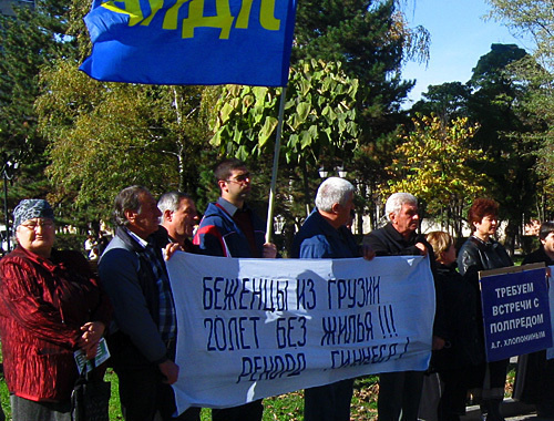 Forced migrants, participants of the LDPR picket. Poster on the left: "Refugees from Georgia are 20 years without housing!!! Guinness record!" Poster on the right: "We demand meeting with Plenipotentiary A. G. Khloponin!" Vladikavkaz, Victory Square, November 4, 2010. Photo by the "Caucasian Knot" Forced migrants, participants of the LDPR picket. Poster on the left: "Refugees from Georgia are 20 years without housing!!! Guinness record!" Poster on the right: "We demand meeting with Plenipotentiary A. G. Khloponin!" Vladikavkaz, Victory Square, November 4, 2010. Photo by the "Caucasian Knot"