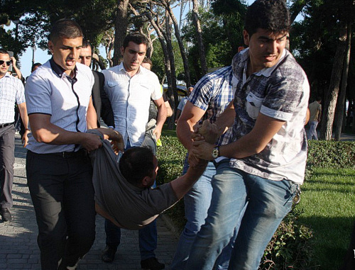 Azerbaijan, Baku, May 25, 2012: men in civilian clothes detain participants of promenade in Primorskiy Boulevard. Courtesy of the IA "Turan" Azerbaijan, Baku, May 25, 2012: men in civilian clothes detain participants of promenade in Primorskiy Boulevard. Courtesy of the IA "Turan"