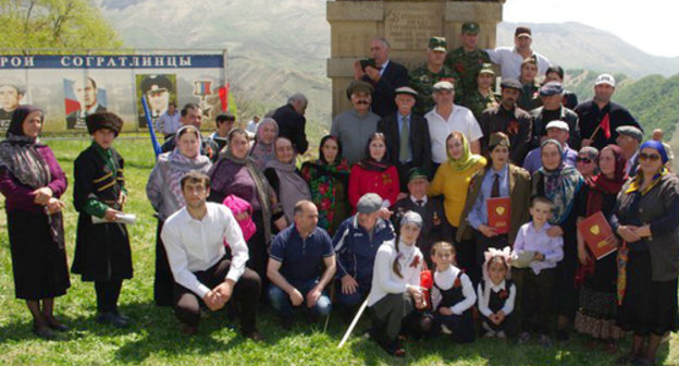 Residents of the village of Sogratl take photo on the Victory day near the monument to the soldiers of the Great Patriotic War damaged by the explosion the day before. May 9, 2014. Photo http://sovet.sogratl.net/ Residents of the village of Sogratl take photo on the Victory day near the monument to the soldiers of the Great Patriotic War damaged by the explosion the day before. May 9, 2014. Photo http://sovet.sogratl.net/