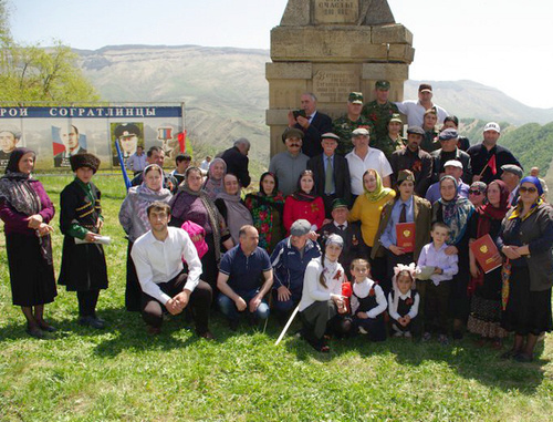 Residents of the village of Sogratl take photo on the Victory day near the monument to the soldiers of the Great Patriotic War damaged by the explosion the day before. May 9, 2014. Photo http://sovet.sogratl.net/ Residents of the village of Sogratl take photo on the Victory day near the monument to the soldiers of the Great Patriotic War damaged by the explosion the day before. May 9, 2014. Photo http://sovet.sogratl.net/