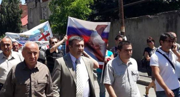 Demonstration in support of restoration of the diplomatic relations with Russia, organised by the NPO coalition "Eurasian Choice-Georgia". Archil Chkoidze, the leader of the coalition, is second from the left. Tbilisi, May 28, 2014. Photo by Maya Khingachashvili, https://www.facebook.com/achiko.chkoidze/photos Demonstration in support of restoration of the diplomatic relations with Russia, organised by the NPO coalition "Eurasian Choice-Georgia". Archil Chkoidze, the leader of the coalition, is second from the left. Tbilisi, May 28, 2014. Photo by Maya Khingachashvili, https://www.facebook.com/achiko.chkoidze/photos