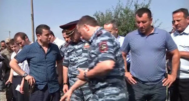 Law enforcers at the place where suspect in police officer’s murder was shot. Grozny, July 3, 2014. Screenshot from the video taken by press-service of Chechen MIA. Law enforcers at the place where suspect in police officer’s murder was shot. Grozny, July 3, 2014. Screenshot from the video taken by press-service of Chechen MIA.