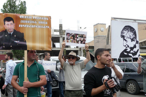 Participants of the action in support of Shant Arutyunyan and other arrested activists of "Million Mask March" carry posters in support of arrested of Volodya Avetisyan, a Karabakh War veteran, with the inscription "Armenia without political prisoners", and of Shant Arutyunyan with the inscription "Freedom to the political prisoners". Yerevan, June 12, 2014. Photo by Armine Martirosyan for the "Caucasian Knot" Participants of the action in support of Shant Arutyunyan and other arrested activists of "Million Mask March" carry posters in support of arrested of Volodya Avetisyan, a Karabakh War veteran, with the inscription "Armenia without political prisoners", and of Shant Arutyunyan with the inscription "Freedom to the political prisoners". Yerevan, June 12, 2014. Photo by Armine Martirosyan for the "Caucasian Knot"