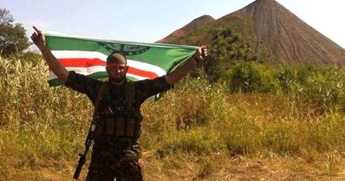 Chechen voluteer with Ichkeria flag in his hands. Photo: http://timer.od.ua/statji/volch_e_znamya_nad_donbassom_832.html Chechen voluteer with Ichkeria flag in his hands. Photo: http://timer.od.ua/statji/volch_e_znamya_nad_donbassom_832.html