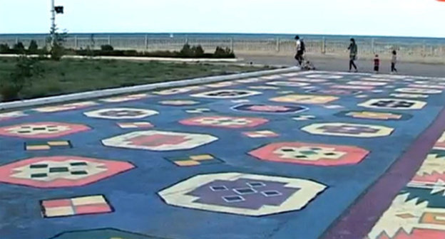 Dagestani ornament painted on an asphalt road in front of the entrance to the exhibition. Photo: still frame of a report by the Republican State Broadcasting Company "Dagestan" http://rgvktv.ru/ Dagestani ornament painted on an asphalt road in front of the entrance to the exhibition. Photo: still frame of a report by the Republican State Broadcasting Company "Dagestan" http://rgvktv.ru/