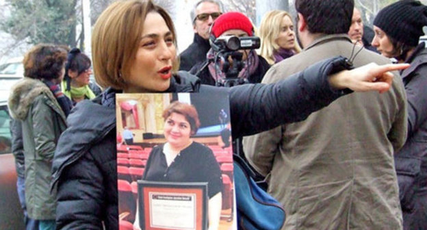 Nino Daneliya, a participant of the action, holds a poster with the photo of the journalist Khadija Ismayilova. Tbilisi, December 10, 2014. Photo by Edita Badasyan for the "Caucasian Knot Nino Daneliya, a participant of the action, holds a poster with the photo of the journalist Khadija Ismayilova. Tbilisi, December 10, 2014. Photo by Edita Badasyan for the "Caucasian Knot