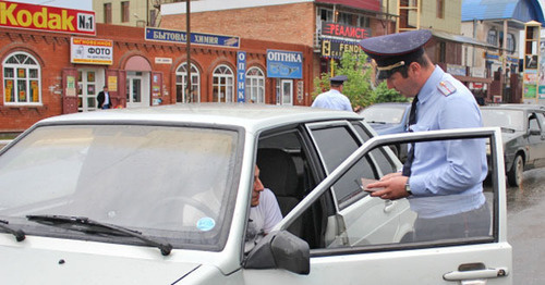 Law enforcement officer checking documents. Photo: MIA of Ingushetia, http://06.mvd.ru Law enforcement officer checking documents. Photo: MIA of Ingushetia, http://06.mvd.ru