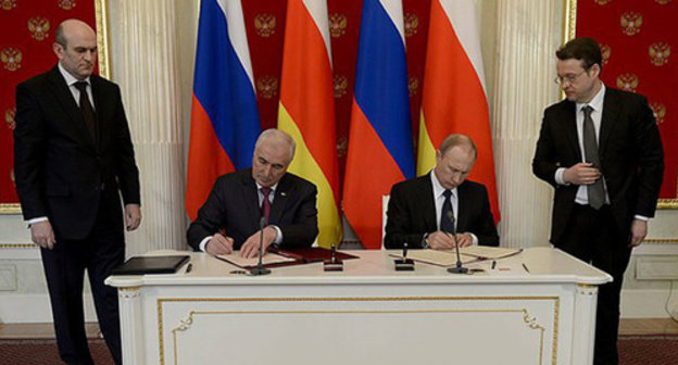 Vladimir Putin (right) and Leonid Tibilov (left) signing Russian-South-Ossetian alliance and integration treaty. Vladimir Putin (right) and Leonid Tibilov (left) signing Russian-South-Ossetian alliance and integration treaty.