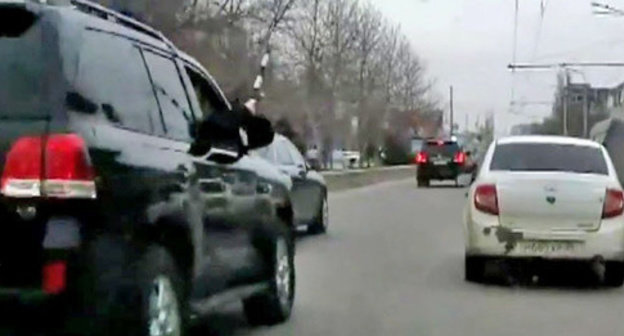 The security guard from the jeep of the convoy of the head of the republic Ramazan Abdulatipov beating the side mirrors of the surrounding cars with a police truncheon. Makhachkala, April 1, 2015. Screenshot of a video by the user MishkaKG http://www.youtube.com/watch?v=GZzEzujUah8 The security guard from the jeep of the convoy of the head of the republic Ramazan Abdulatipov beating the side mirrors of the surrounding cars with a police truncheon. Makhachkala, April 1, 2015. Screenshot of a video by the user MishkaKG http://www.youtube.com/watch?v=GZzEzujUah8