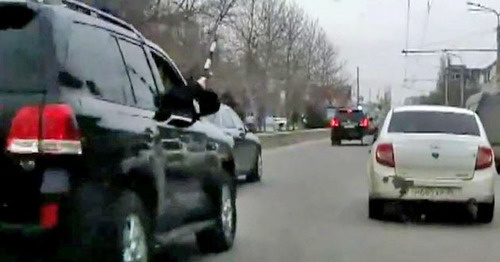 The security guard from the jeep of the convoy of the head of the republic Ramazan Abdulatipov beating the side mirrors of the surrounding cars with a police truncheon. Makhachkala, April 1, 2015. Screenshot of a video by the user MishkaKG http://www.youtube.com/watch?v=GZzEzujUah8 The security guard from the jeep of the convoy of the head of the republic Ramazan Abdulatipov beating the side mirrors of the surrounding cars with a police truncheon. Makhachkala, April 1, 2015. Screenshot of a video by the user MishkaKG http://www.youtube.com/watch?v=GZzEzujUah8