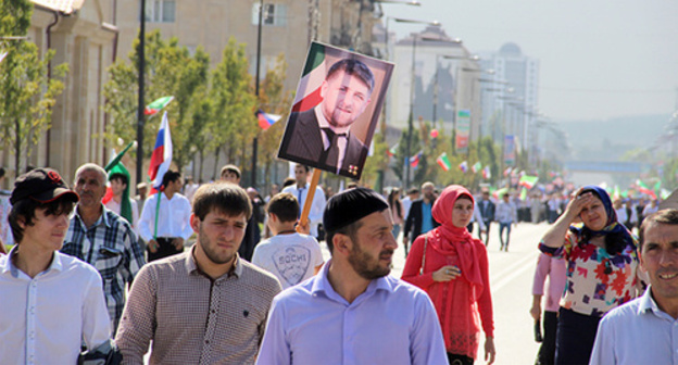 The participants of the celebratory marching holding a portrait of Kadyrov in the street of Grozny. September 2014. Photo by Magomed Magomedov for the "Caucasian Knot" The participants of the celebratory marching holding a portrait of Kadyrov in the street of Grozny. September 2014. Photo by Magomed Magomedov for the "Caucasian Knot"