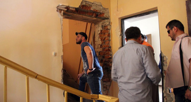 Broken door in the office of the Committee against Torture.
