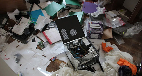 Broken personal computer lying on the heap of papers Broken personal computer lying on the heap of papers