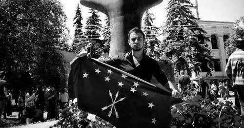 Nartan Kylych holding the Circassian flag in front of a monument to victims of the Caucasian War in Nalchik. Photo: Aslan Schakue, Fatima Tlisova and Olga Efendieva-Begret, https://www.facebook.com/photo.php?fbid=10153411014089002&set=a.10150641558564002.436428.531449001&type=1&fref=nf&pnref=story Nartan Kylych holding the Circassian flag in front of a monument to victims of the Caucasian War in Nalchik. Photo: Aslan Schakue, Fatima Tlisova and Olga Efendieva-Begret, https://www.facebook.com/photo.php?fbid=10153411014089002&set=a.10150641558564002.436428.531449001&type=1&fref=nf&pnref=story