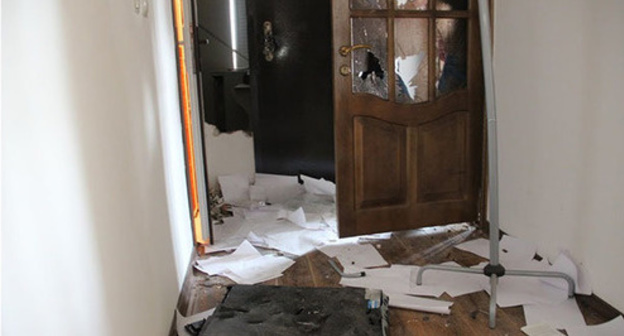 Broken door and scattered documents in the Committee against Torture office in Grozny, June 3, 2015.