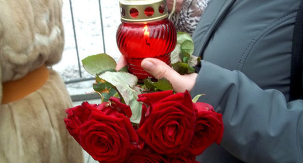 Participant of the funeral service for Boris Nemtsov holds candle and flowers. Moscow, March 3, 2015. Photo by Karina Gadzhieva for the "Caucasian Knot" Participant of the funeral service for Boris Nemtsov holds candle and flowers. Moscow, March 3, 2015. Photo by Karina Gadzhieva for the "Caucasian Knot"