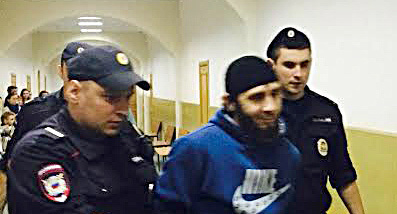 Police officer escorts Zaur Dadaev along the Basmanny Court hallway, Moscow, March 8, 2015. Photo by Yulia Buslavskaya for the ‘Caucasian Knot’ Police officer escorts Zaur Dadaev along the Basmanny Court hallway, Moscow, March 8, 2015. Photo by Yulia Buslavskaya for the ‘Caucasian Knot’