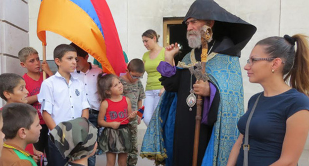 Archbishop Pargev Martirosyan, the leader of the Artsakh Diocese of the Armenian Apostolic Church, had a talk with children in Maraga village and blessed them after
the liturgy for the repose of the two soldiers lost on September 4 in the Karabakh conflict zone. Stepanakert, Nagorno-Karabakh. September 6, 2015. Photo by Alvard Grigoryan for the "Caucasian Knot" Archbishop Pargev Martirosyan, the leader of the Artsakh Diocese of the Armenian Apostolic Church, had a talk with children in Maraga village and blessed them after
the liturgy for the repose of the two soldiers lost on September 4 in the Karabakh conflict zone. Stepanakert, Nagorno-Karabakh. September 6, 2015. Photo by Alvard Grigoryan for the "Caucasian Knot"
