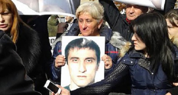 Woman holds a photo of Vladimir Tskaev. Photo by Emma Marzoeva for the "Caucasian Knot" Woman holds a photo of Vladimir Tskaev. Photo by Emma Marzoeva for the "Caucasian Knot"