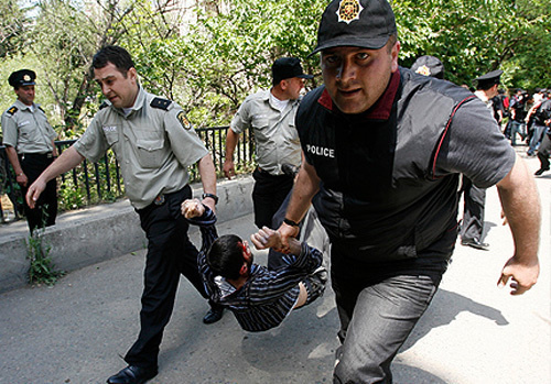 Tbilisi policemen detain oppositional protesters in front of the Chief Interior Administration. July 15, 2009. Photo by http://yugo-vostok.org Tbilisi policemen detain oppositional protesters in front of the Chief Interior Administration. July 15, 2009. Photo by http://yugo-vostok.org
