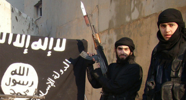 IS supporters near the "Islamic State" flag (Islamic State is a terrorist organization banned in Russia). Photo by user Vesti Detalno, www.flickr.com IS supporters near the "Islamic State" flag (Islamic State is a terrorist organization banned in Russia). Photo by user Vesti Detalno, www.flickr.com