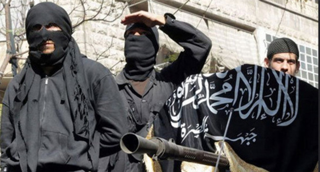 IS supporters hold Islamic State flag (Islamic State is a terrorist organization banned in Russia). Photo by user Chief Editor, www.flickr.com