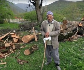 Georgy Doskoynov, a 79 year ethnic Udi living in the Oghuz city in Azerbaijan, near the cut down tree. Screenshot of a video by the "Caucasian Knot" Georgy Doskoynov, a 79 year ethnic Udi living in the Oghuz city in Azerbaijan, near the cut down tree. Screenshot of a video by the "Caucasian Knot"