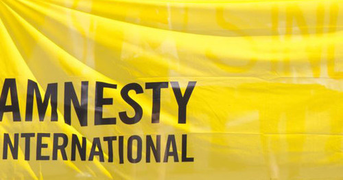 Flag with Amnesty International logo. Photo: RFE/RL Flag with Amnesty International logo. Photo: RFE/RL