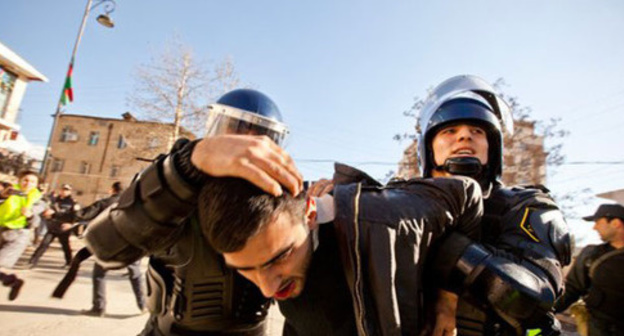 Policemen detain rally participant. Photo: http://haqqin.az/news/88222 Policemen detain rally participant. Photo: http://haqqin.az/news/88222