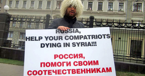 A Circassian activist with a poster standing at the solo picket. Photo: RFE/RL A Circassian activist with a poster standing at the solo picket. Photo: RFE/RL