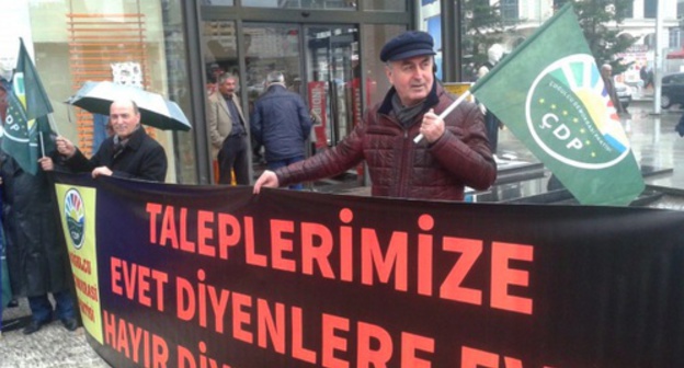An activist with a poster in support of creating a television channel in the Circassian language in Turkey. Photo: Cerkesfed.org An activist with a poster in support of creating a television channel in the Circassian language in Turkey. Photo: Cerkesfed.org