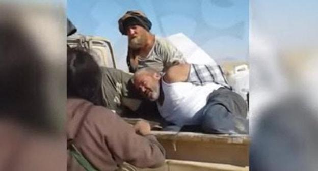 Still picture from the video showing captivity of the Cossack Roman Zabolotniy in Syria: https://www.youtube.com/watch?v=2QkDaZNGxsY Still picture from the video showing captivity of the Cossack Roman Zabolotniy in Syria: https://www.youtube.com/watch?v=2QkDaZNGxsY
