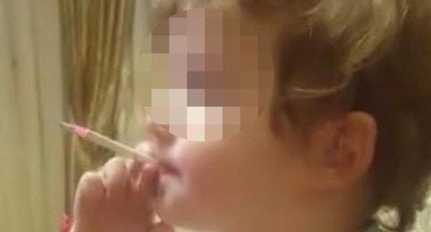 Screenshot of a video with a smoking child. Photo https://www.facebook.com/groups/respublikaalania/permalink/197991943232979 Screenshot of a video with a smoking child. Photo https://www.facebook.com/groups/respublikaalania/permalink/197991943232979