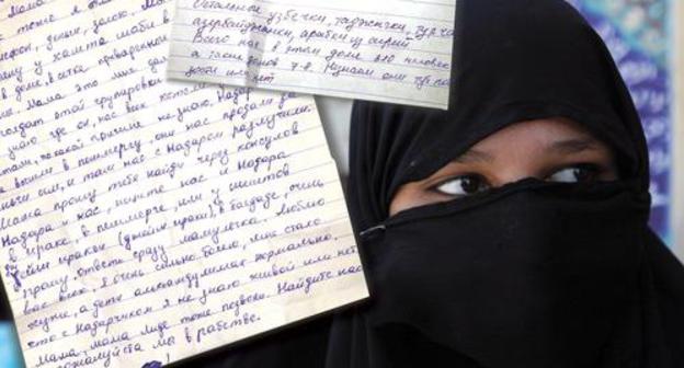 Letters and woman in hijab. Photo: Reuters/Alaa Al-Marjani Letters and woman in hijab. Photo: Reuters/Alaa Al-Marjani