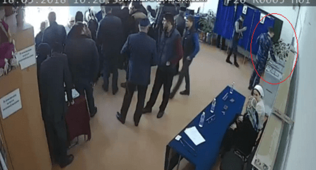 Man in camouflage drops three ballots into the election box at a polling station in Argun. Screenshot from video twitter.com/Press_Focusnik/status/975311003201228801 Man in camouflage drops three ballots into the election box at a polling station in Argun. Screenshot from video twitter.com/Press_Focusnik/status/975311003201228801