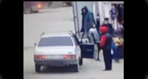 Teenager near the car. Screenshot from video posted by Nurmagomeg Astarkhanov,
https://www.youtube.com/watch?time_continue=34&v=A8kHYg7CJlU
