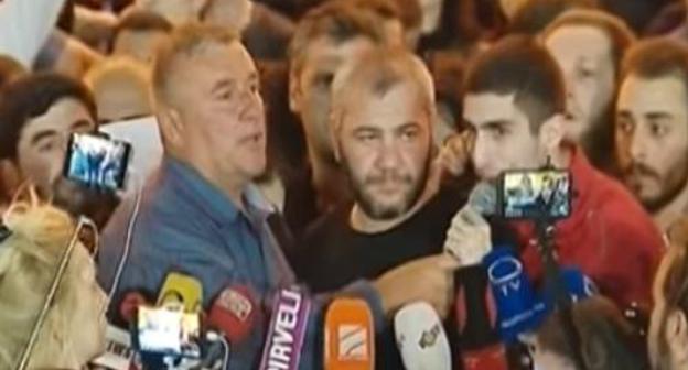 Fathers of killed teenagers surrounded by journalists at a protest action in Tbilisi on June 1, 2018. Levan Dadunashvili's father is on the left, Zaza Saralidze's father is on the right. Screenshot of the video https://1tv.ge Fathers of killed teenagers surrounded by journalists at a protest action in Tbilisi on June 1, 2018. Levan Dadunashvili's father is on the left, Zaza Saralidze's father is on the right. Screenshot of the video https://1tv.ge