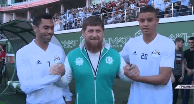 Ramzan Kadyrov with the Egyptian national football team players. Screenshot of the video report by the Grozny TV Channel on June 10, 2018 https://www.youtube.com/watch?v=JCkgo4v_KnA Ramzan Kadyrov with the Egyptian national football team players. Screenshot of the video report by the Grozny TV Channel on June 10, 2018 https://www.youtube.com/watch?v=JCkgo4v_KnA