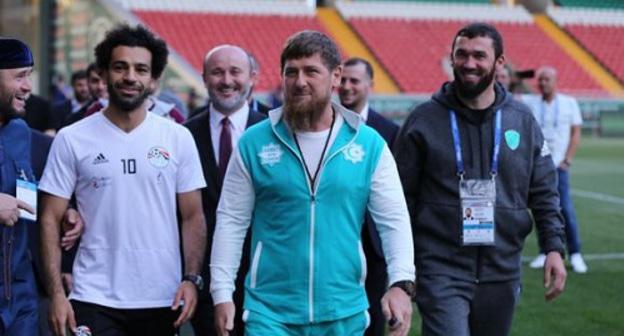 Mohamed Salah, Ramzan Kadyrov and Magomed Daudov (from left to right) visit stadium in Grozny. Photo by provided by press service of the Chechen Parliament, http://www.parlamentchr.ru/press-centre/news/7382-v-groznyj-pribyla-sbornaya-egipta-po-futbolu Mohamed Salah, Ramzan Kadyrov and Magomed Daudov (from left to right) visit stadium in Grozny. Photo by provided by press service of the Chechen Parliament, http://www.parlamentchr.ru/press-centre/news/7382-v-groznyj-pribyla-sbornaya-egipta-po-futbolu