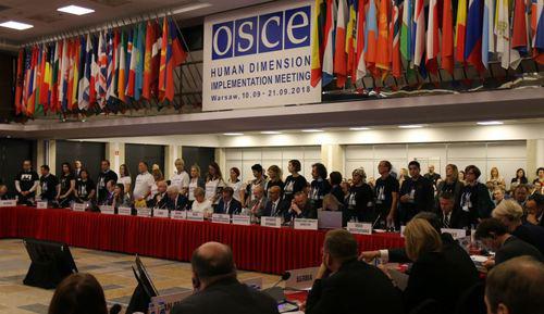 Action in support of Titiev and Sentsov at the OSCE conference in Warsaw, September 10, 2018. Photo from channel of the HRC "Memorial", https://web.telegram.org/#/im?p=@hrcmemorial Action in support of Titiev and Sentsov at the OSCE conference in Warsaw, September 10, 2018. Photo from channel of the HRC "Memorial", https://web.telegram.org/#/im?p=@hrcmemorial