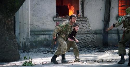 Fighter is taking a child away from the burning building in Sukhumi, 1993. Photo: Andrei Soloviev, RFE/RL Fighter is taking a child away from the burning building in Sukhumi, 1993. Photo: Andrei Soloviev, RFE/RL