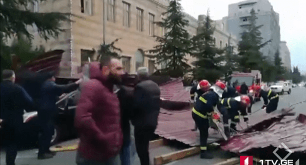 Rescuers clear the debris after hurricane in Batumi. Screenshot from video reportage by First Channel, https://1tv.ge/ru/news/silnyj-veter-v-batumi-sorval-kryshu-s-zhilogo-doma-est-postradavshie/ Rescuers clear the debris after hurricane in Batumi. Screenshot from video reportage by First Channel, https://1tv.ge/ru/news/silnyj-veter-v-batumi-sorval-kryshu-s-zhilogo-doma-est-postradavshie/