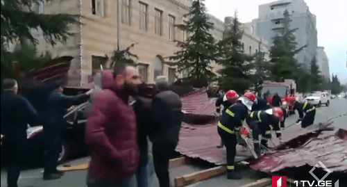 Rescuers clear the debris after hurricane in Batumi. Screenshot from video reportage by First Channel, https://1tv.ge/ru/news/silnyj-veter-v-batumi-sorval-kryshu-s-zhilogo-doma-est-postradavshie/ Rescuers clear the debris after hurricane in Batumi. Screenshot from video reportage by First Channel, https://1tv.ge/ru/news/silnyj-veter-v-batumi-sorval-kryshu-s-zhilogo-doma-est-postradavshie/