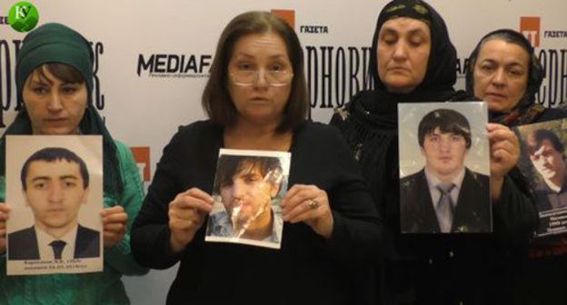 Relatives of the eight young people from Dagestan killed in Chechnya holding their photos. Screenshot of the video by the "Caucasian Knot" Relatives of the eight young people from Dagestan killed in Chechnya holding their photos. Screenshot of the video by the "Caucasian Knot"