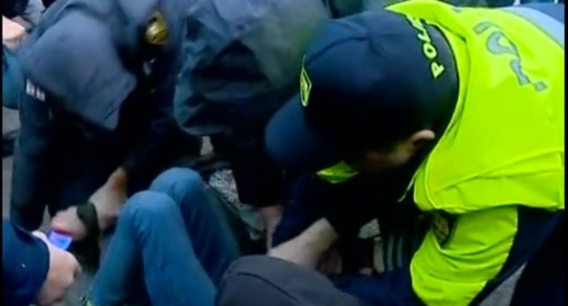 The police detains an activist. Screenshot of the video http://rustavi2.ge/en/news/152309 The police detains an activist. Screenshot of the video http://rustavi2.ge/en/news/152309