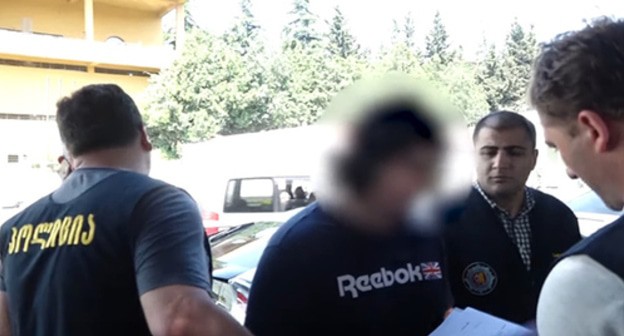 The detention of Mikhail Kalandiya. Screenshot of the video posted at the YouTube პირველი არხი Georgian Public Broadcaster https://www.youtube.com/watch?v=nmvggRz3Q-Q&feature=emb_logo The detention of Mikhail Kalandiya. Screenshot of the video posted at the YouTube პირველი არხი Georgian Public Broadcaster https://www.youtube.com/watch?v=nmvggRz3Q-Q&feature=emb_logo