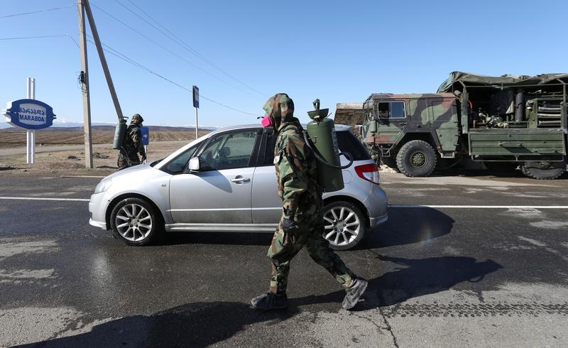 A cleaning services specialist disinfects streets in the village of Marabda. March 23, 2020. Photo: REUTERS/Irakli Gedenidze A cleaning services specialist disinfects streets in the village of Marabda. March 23, 2020. Photo: REUTERS/Irakli Gedenidze