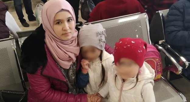 Elmira Kenzhibulatova with her children in an airport. Photo courtesy of Rasul Kenzhibulatov Elmira Kenzhibulatova with her children in an airport. Photo courtesy of Rasul Kenzhibulatov