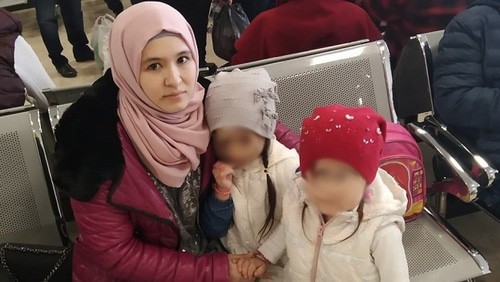 Elmira Kenzhibulatova with her children in an airport. Photo courtesy of Rasul Kenzhibulatov Elmira Kenzhibulatova with her children in an airport. Photo courtesy of Rasul Kenzhibulatov