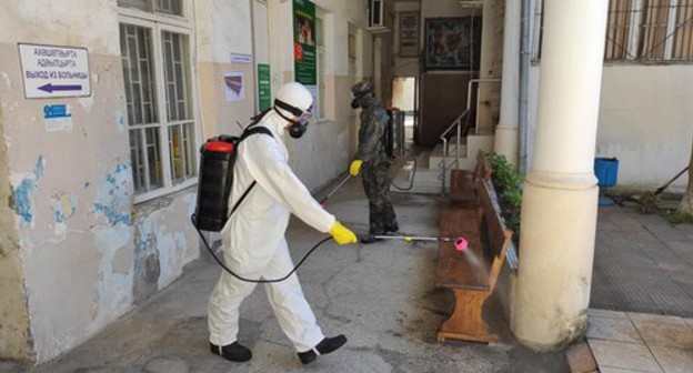 Worker in a protective suit is conducting disinfection, Abkhazia. Photo: press service of the Ministry for Emergencies of Abkhazia Worker in a protective suit is conducting disinfection, Abkhazia. Photo: press service of the Ministry for Emergencies of Abkhazia